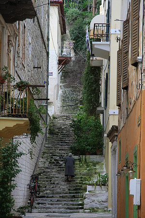 A lady makes her way up a flight of stairs