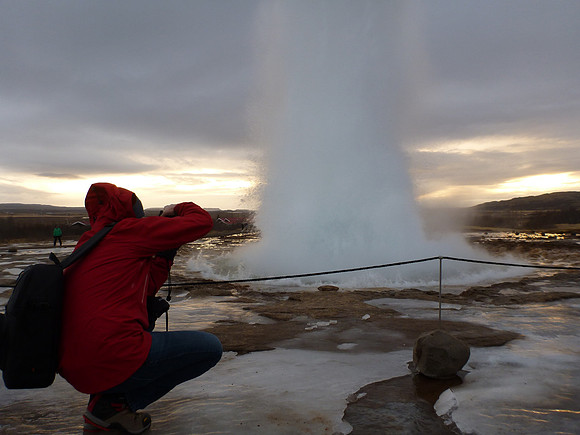 Behind the photographer.