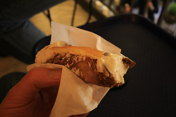 Cannoli at Antica Focacceria San Francesco - notice the technique and use of paper to hold it