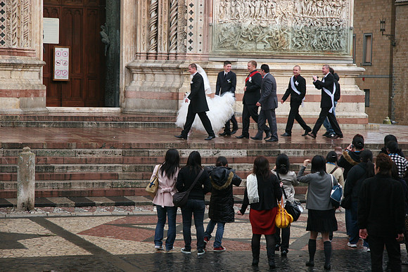 A Japanese Tour Group Photographs a Polish Wedding in an Italian City
