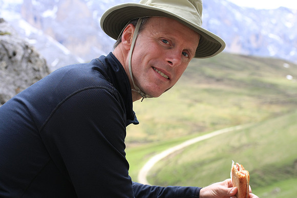 Mark snacks on a speck and cheese sandwich.