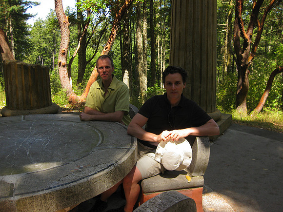 Sitting at the table. Ashes are under each chair.