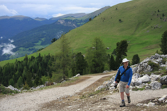 The trail merges with a utility road.