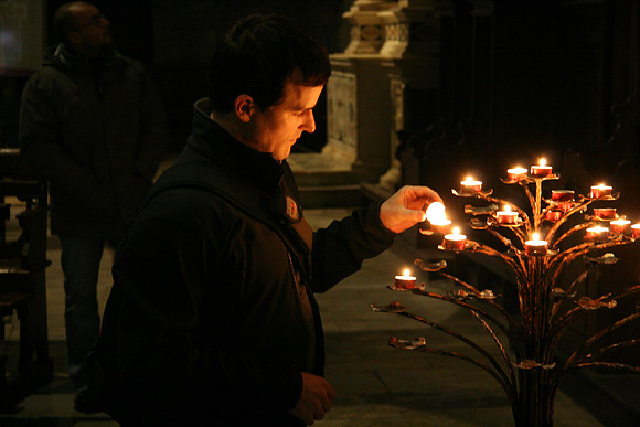 Lighting candles inside San Michele "in Foro"