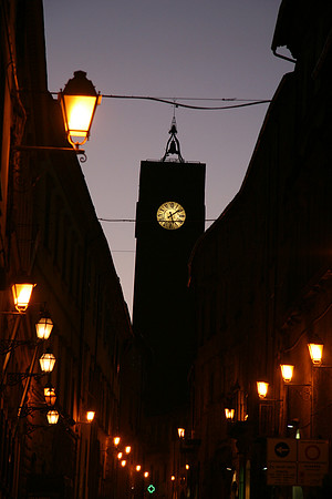 Corso Cavour at dusk with Torre del Moro
