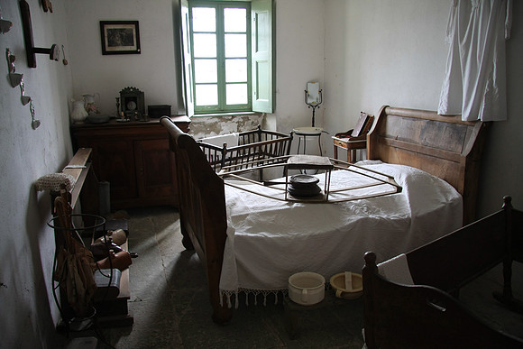 Bedroom in the museum with bed warmer