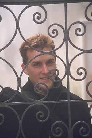 Staring through a gate.