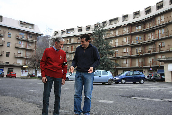 Marc showing Andrea how he knows Italian hand signals. Our dark blue Renault 'Scenic' in background